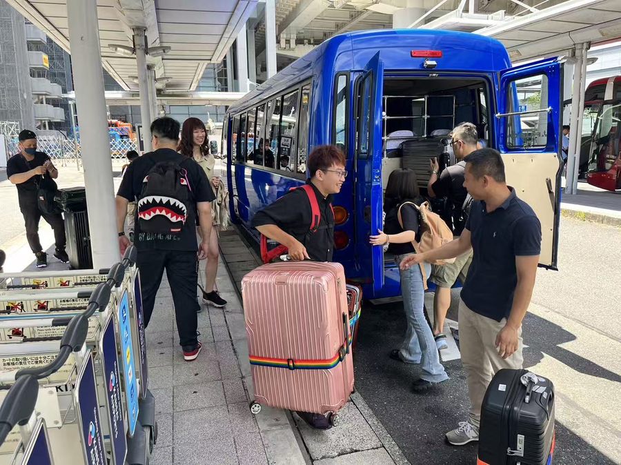 Driver loading luggage at the airport