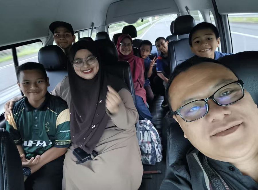 Smiling guests inside the private van