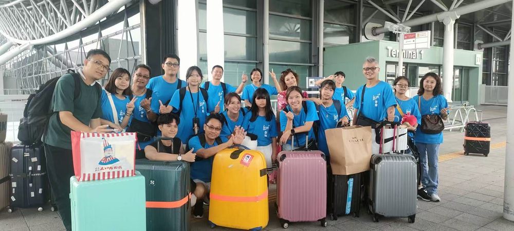 A large group with luggage gathered at Kansai Airport
